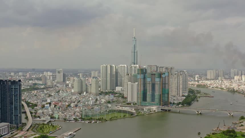 City skyline with large skyscrapers and high rise next to a river