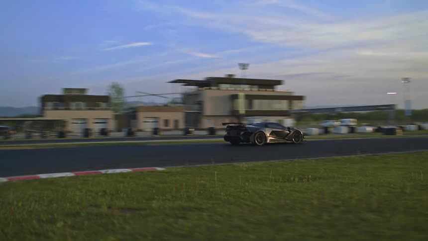 A sports car makes a hard right turn on an outdoor track