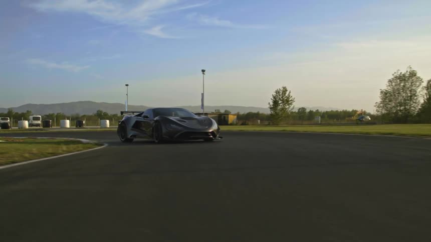 A sports car makes multiple quick turns on an outdoor track