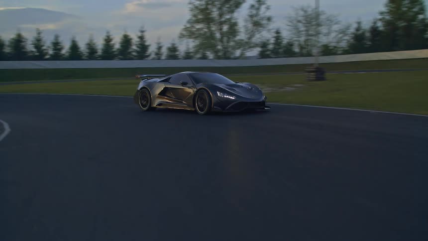 A sports car driving on a track with trees the sky and clouds in the background