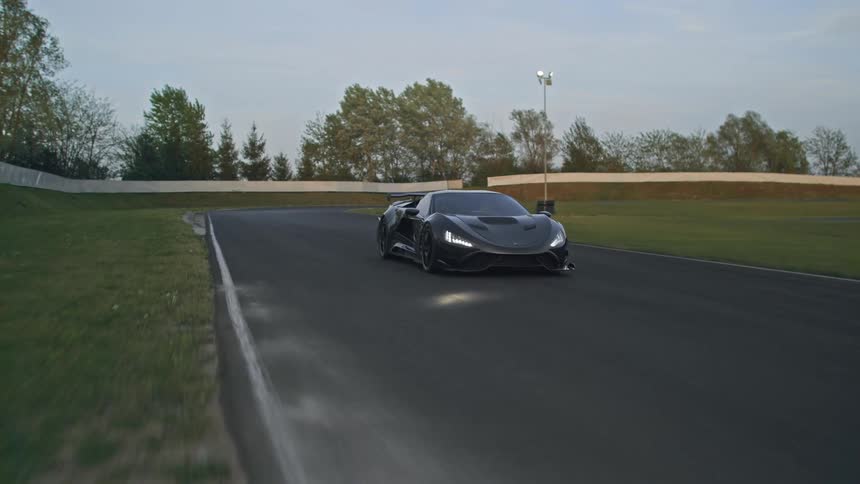 A car is driving on a racetrack in spring