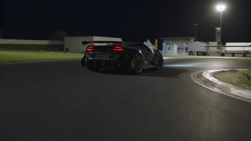 A sports car drives on a track