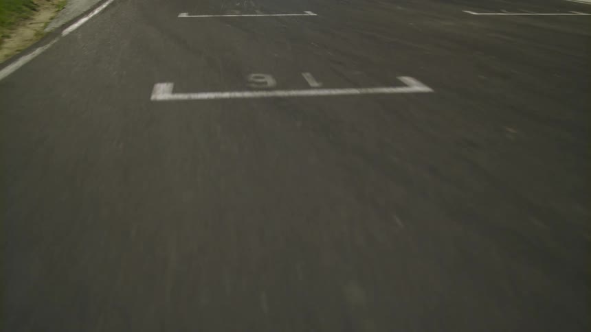 Race track at night with a car in the distance