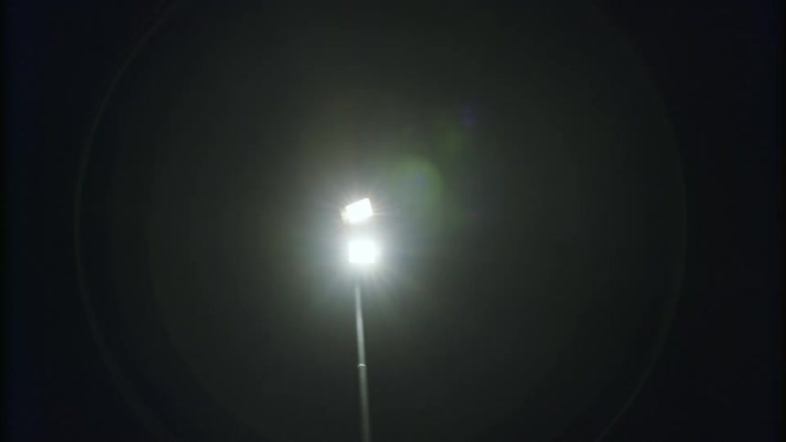 Bright street light shining down at nighttime