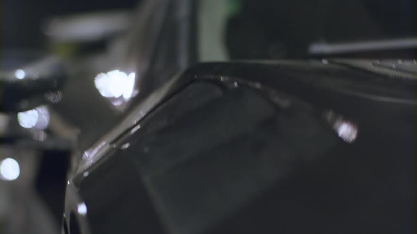 Lights shining on a black sports car