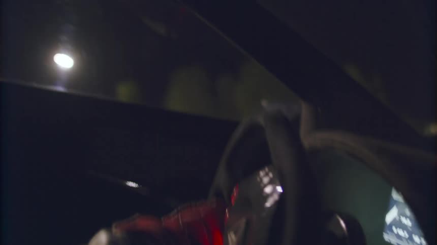 A person is driving a car at night