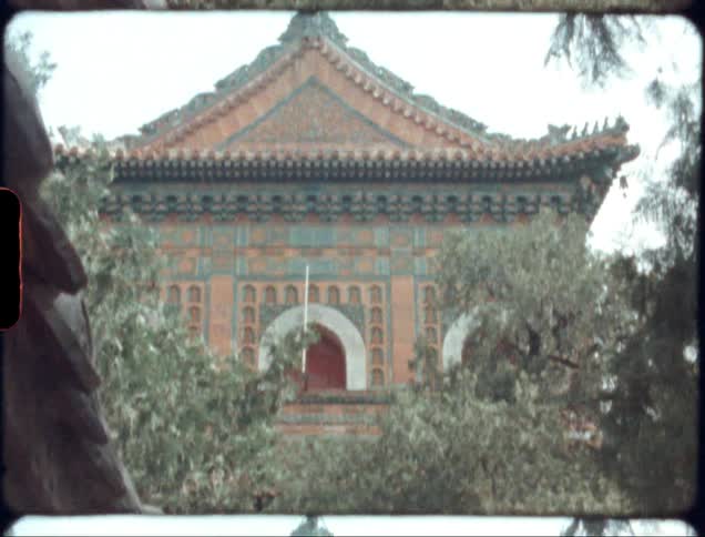 Exterior of an asian temple during the day with trees around it