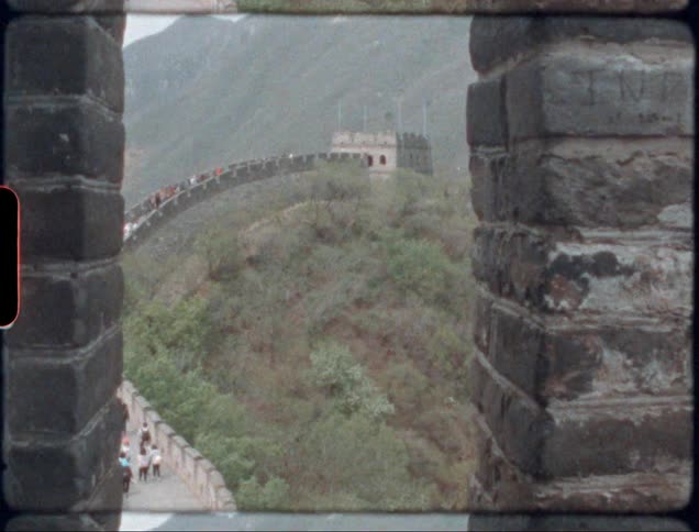 People walk across top of great wall of china