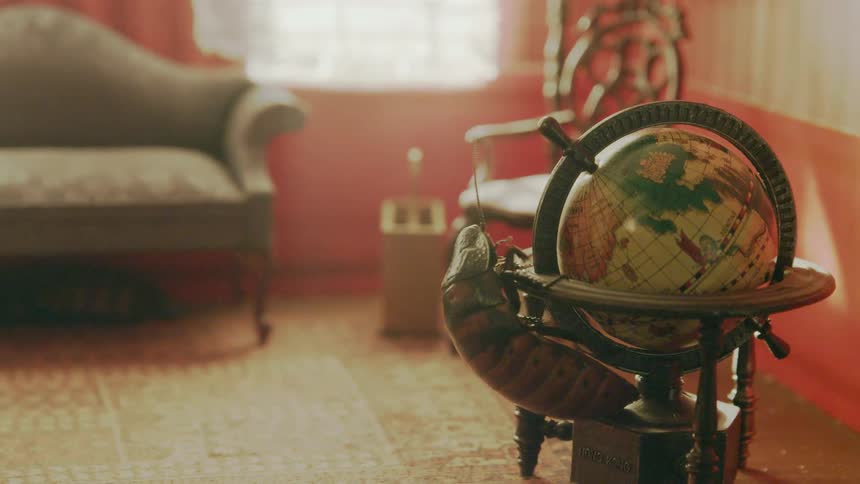 A cockroach crawling on a globe in a dollhouse