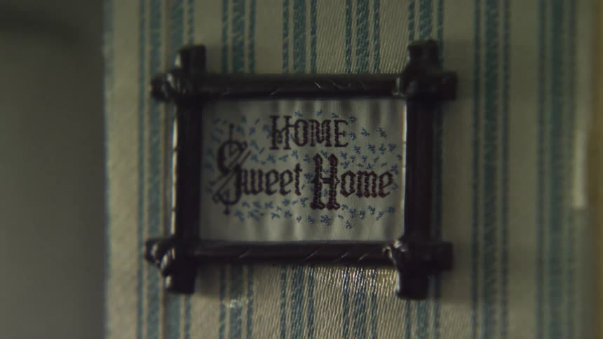 A cross stitch hanging in a home