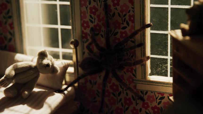 Light swings on and off tarantula crawling along wall in dollhouse