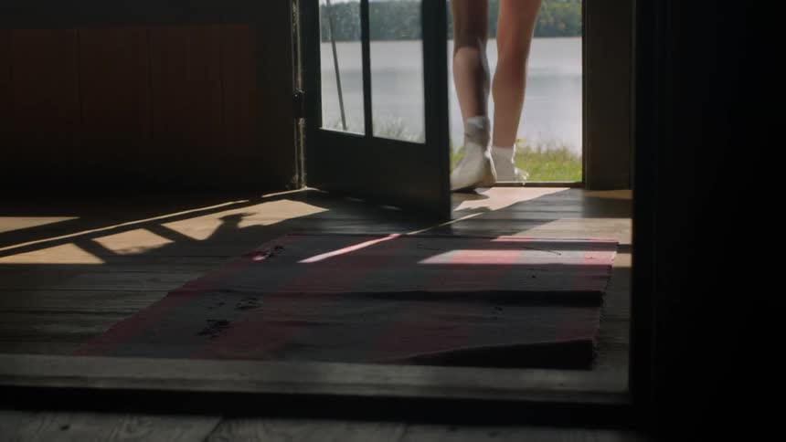 A woman walks out of a door