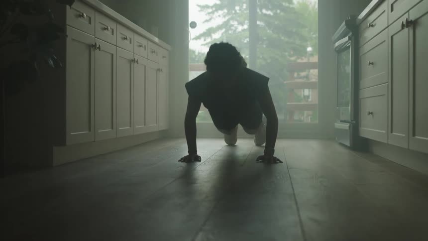 A person is exercising on their kitchen floor