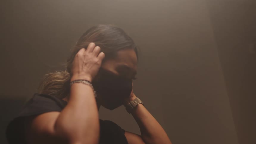 Asian woman with a brown hair wears a black mask