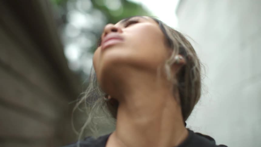 A woman stretches her neck and looks forward