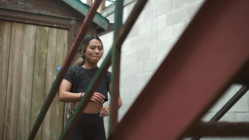 A teenage girl exercising in a neighborhood