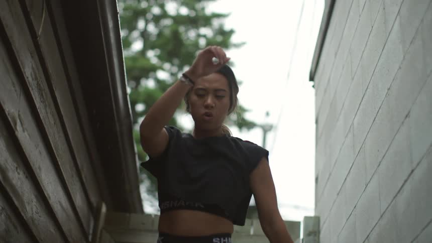 A young woman exercising in a neighborhood