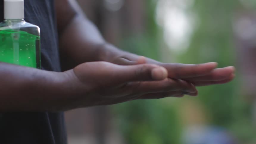 A child with hand sanitizer sanitizing their hands