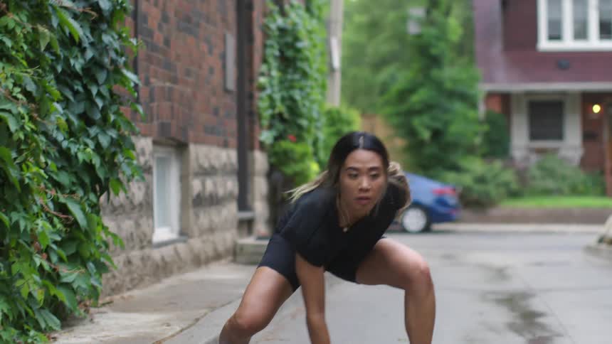 A young woman exercising in a neighborhood