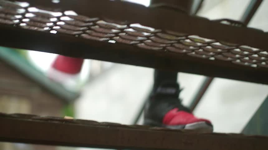 A man is jogging up a flight of stairs