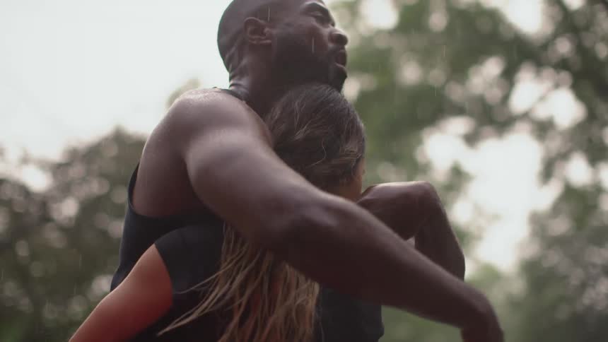 Male and female hugging in the street