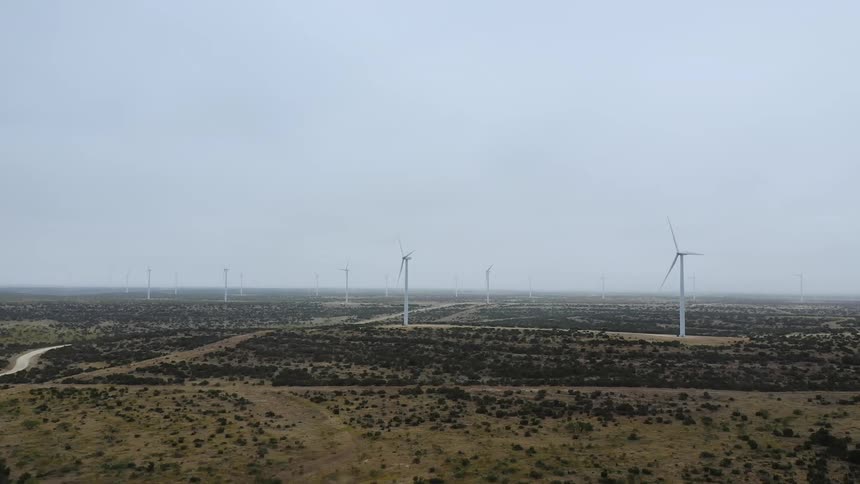 Aerial view of windmills in a rural area is displayed