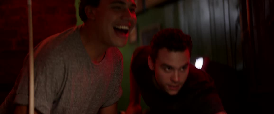 Group of friends teasing each other playing pool