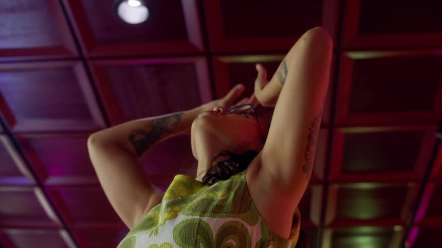 A woman does a modern dance in a bar