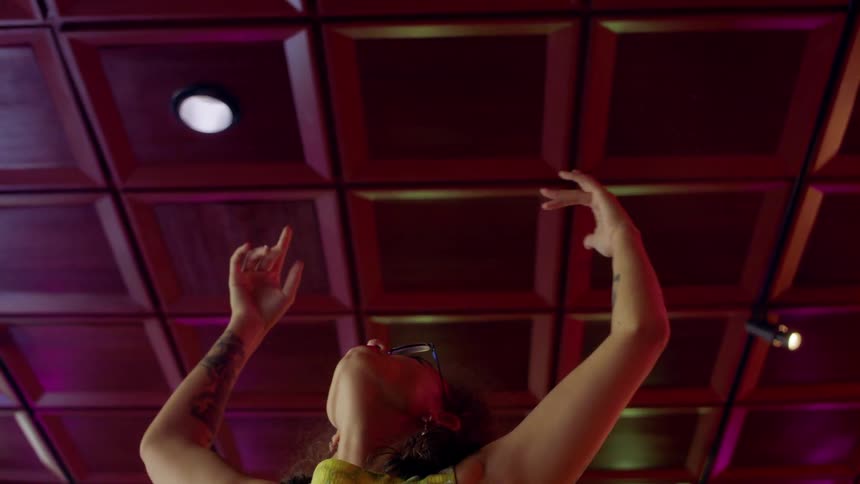 Woman stretching and moving her arms into a dance pose