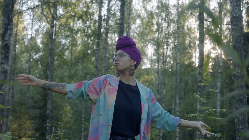 Woman performing a spiritual dance in a forest