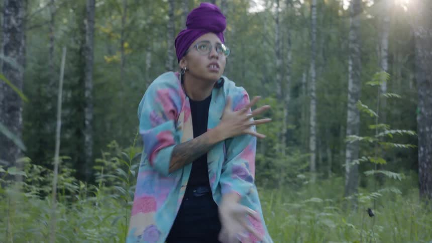 A woman is standing in a forest