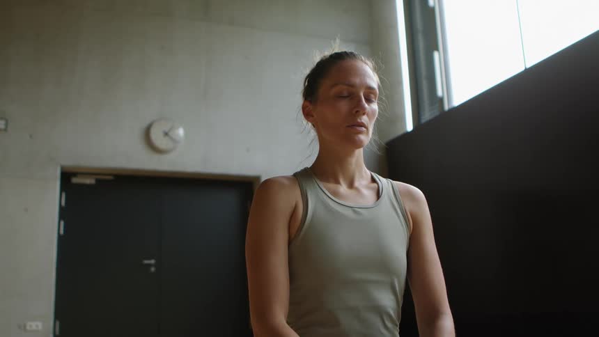 A woman is doing yoga in a room