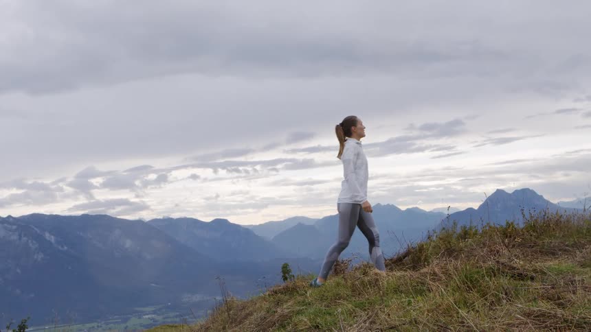 A woman is jogging outdoors