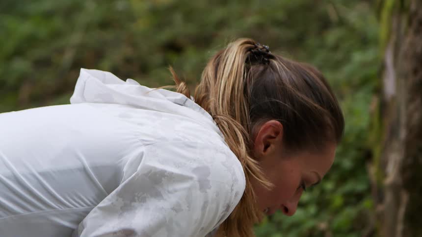 Woman catching her breath out on a running trail in nature