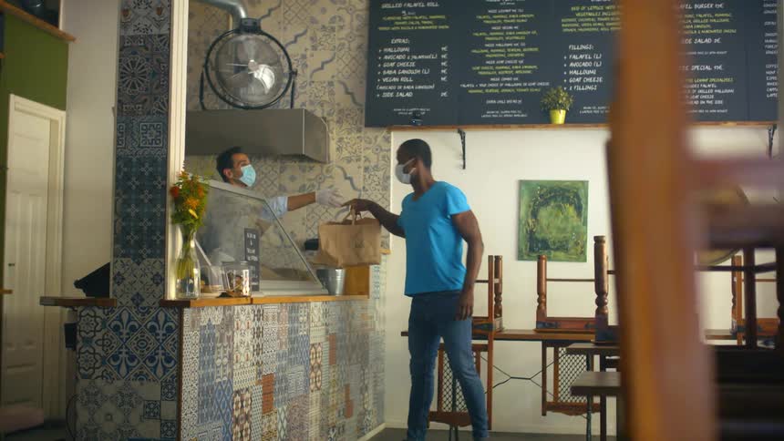 Customer picking up order take out from restaurant during pandemic