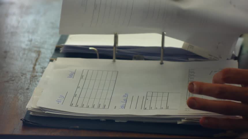 A man in an office goes through paperwork