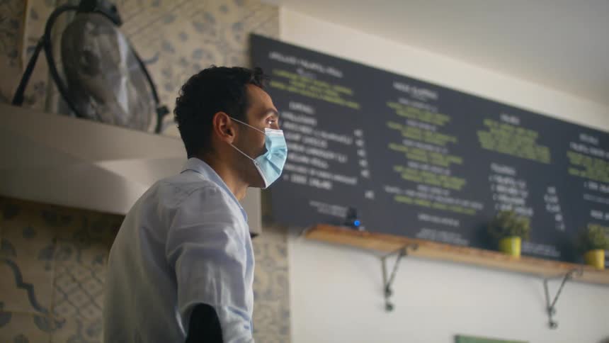 A male worker in a restaurant cleans up during the day