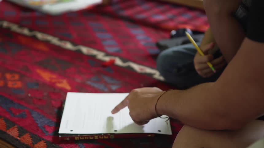 A father and son sitting together working on homework