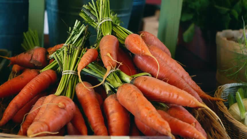 Carrots and produce on baskets for sale on display