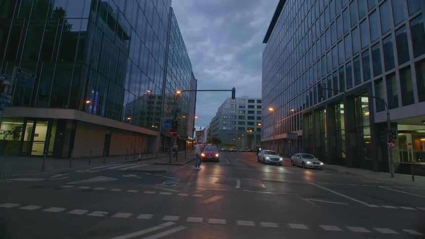 A person walks across a street using a crosswalk