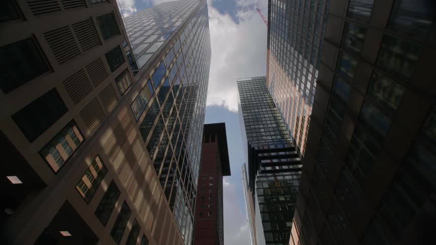 Tall city buildings that are very high in the sky