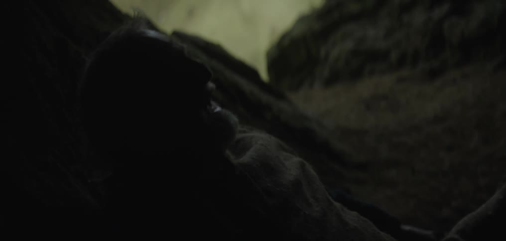 A man runs into a cave and lies down