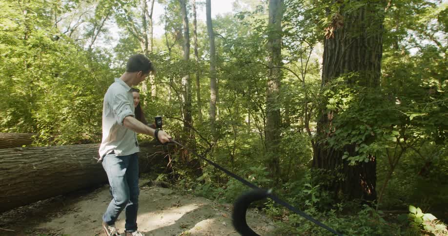 Couple walking in a forest with dog