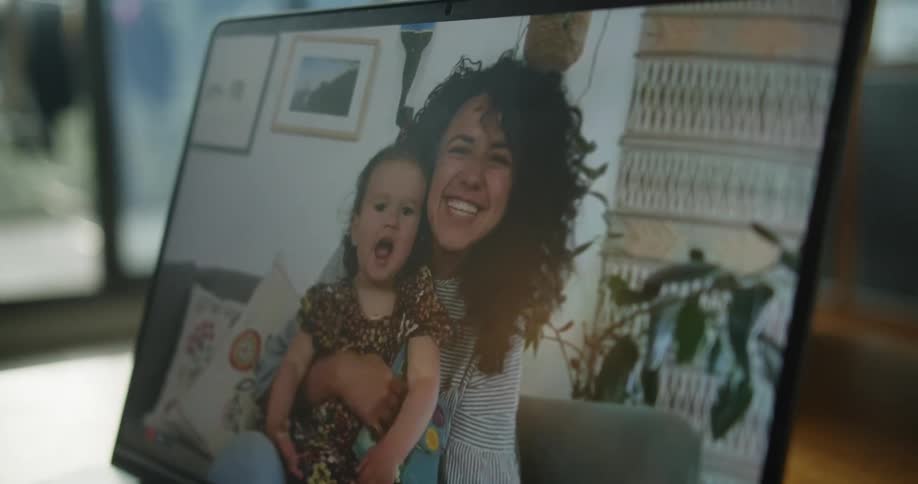 Mother and daughter on a tablet screen waving goodbye to the camera
