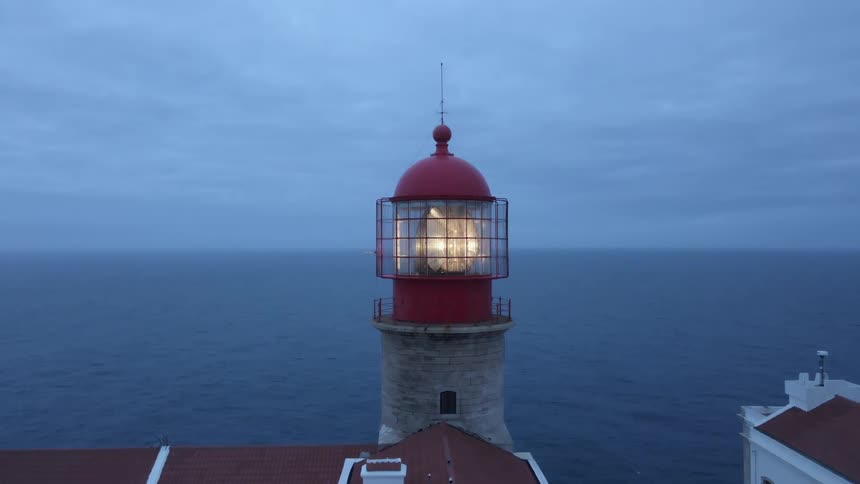A lighthouse with a light beacon on a large body of water