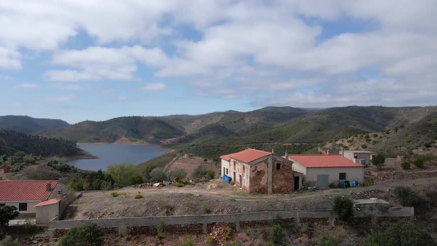 Narrow roads wind along hills where homes sit far apart and near a lake