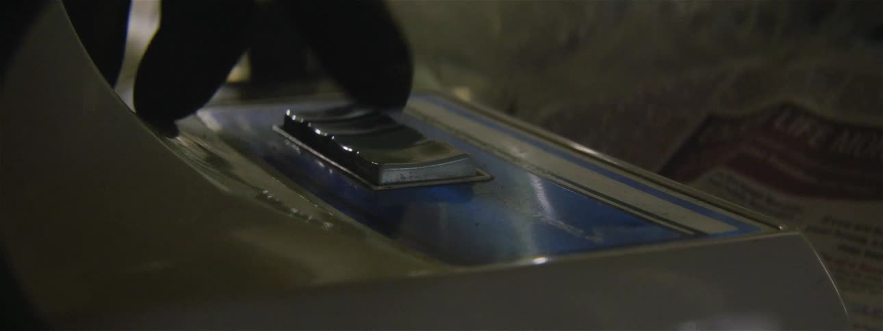 A finger presses a button