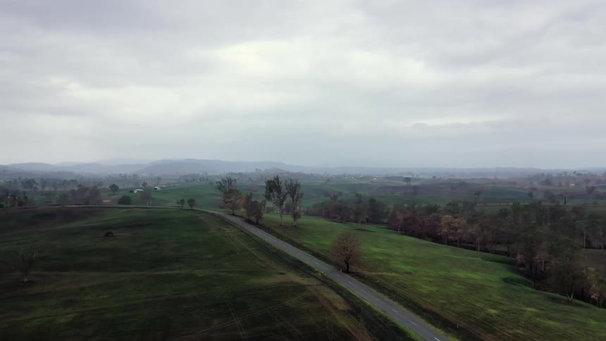Aerial view of countryside with a road and overcast weather