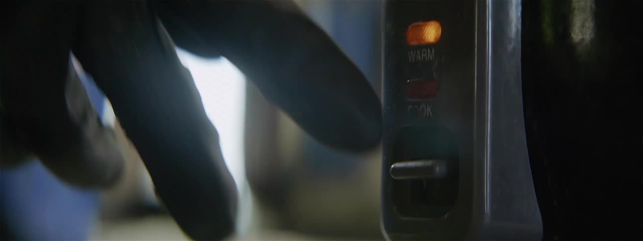 A person pushes a button on an appliance
