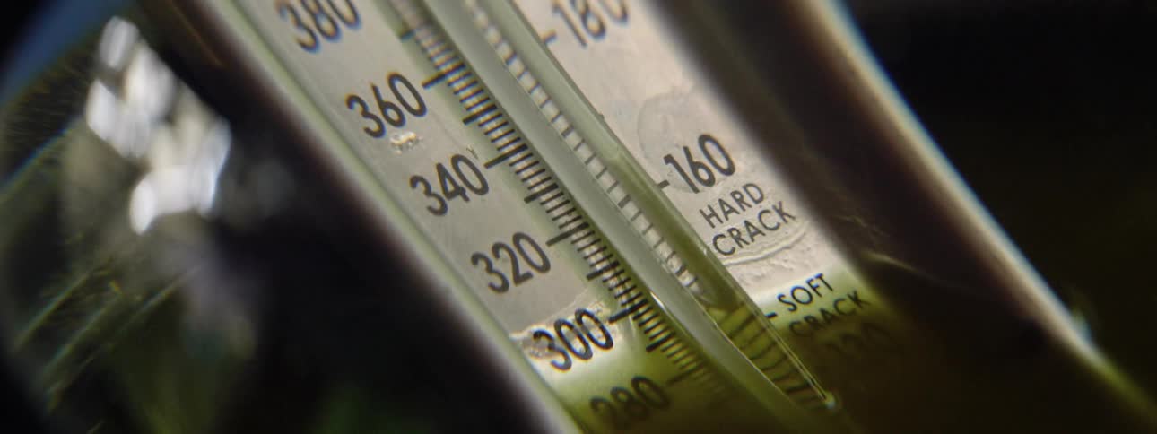 A thermometer sitting in a pot with water